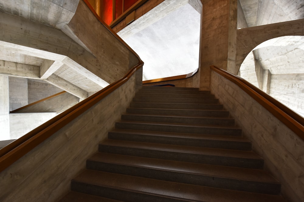 brown wooden staircase with white and brown tiles