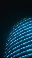 Close-up of a modern illuminated totem sign with blue and white lighting