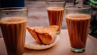 bread on white ceramic plate beside drinking glass