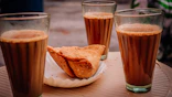bread on white ceramic plate beside drinking glass