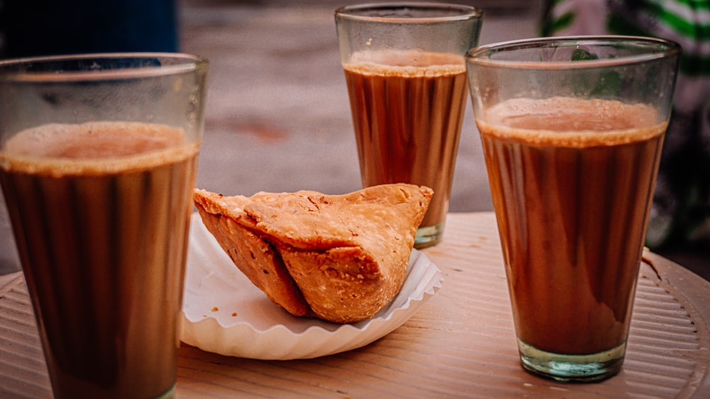 bread on white ceramic plate beside drinking glass