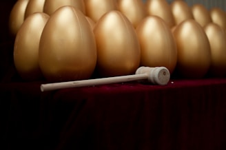A collection of remote-controlled pleasure eggs displayed elegantly on a polished wooden surface.