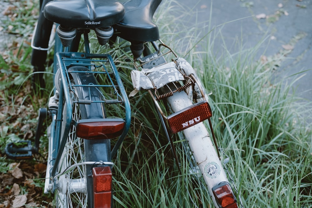 red and white bicycle on green grass during daytime