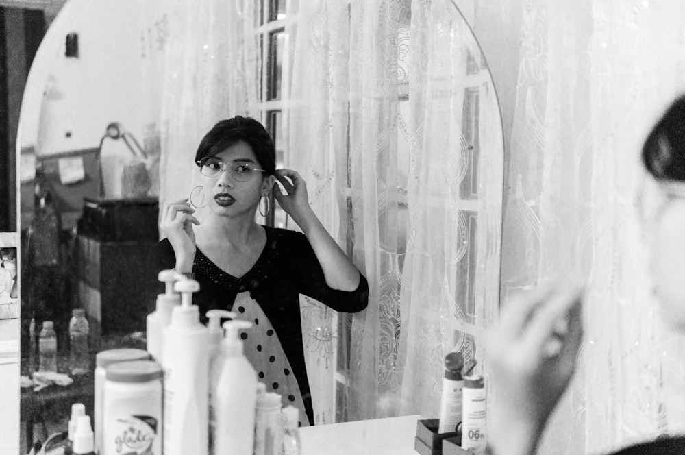 woman in black shirt drinking water