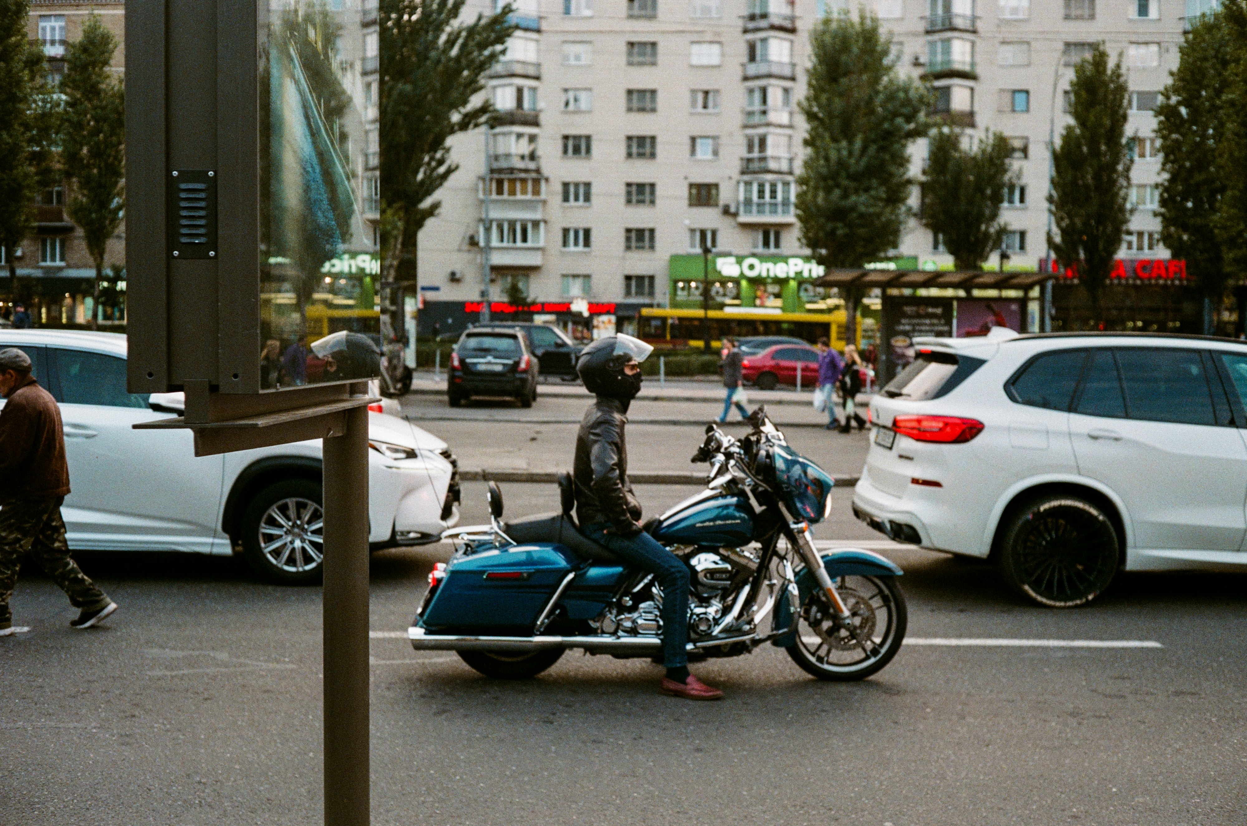 man in blue motorcycle on road during daytime