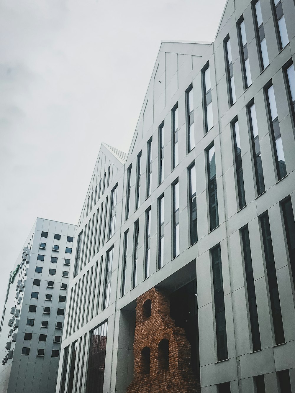 white concrete building under white sky during daytime