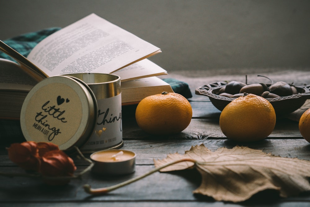 orange fruit beside white ceramic mug