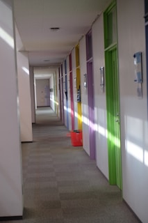 A glowing cosmic hallway with four radiant doors, each symbolizing a different life stage.