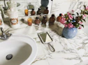 Artisan installing granite countertop on a custom bathroom vanity.