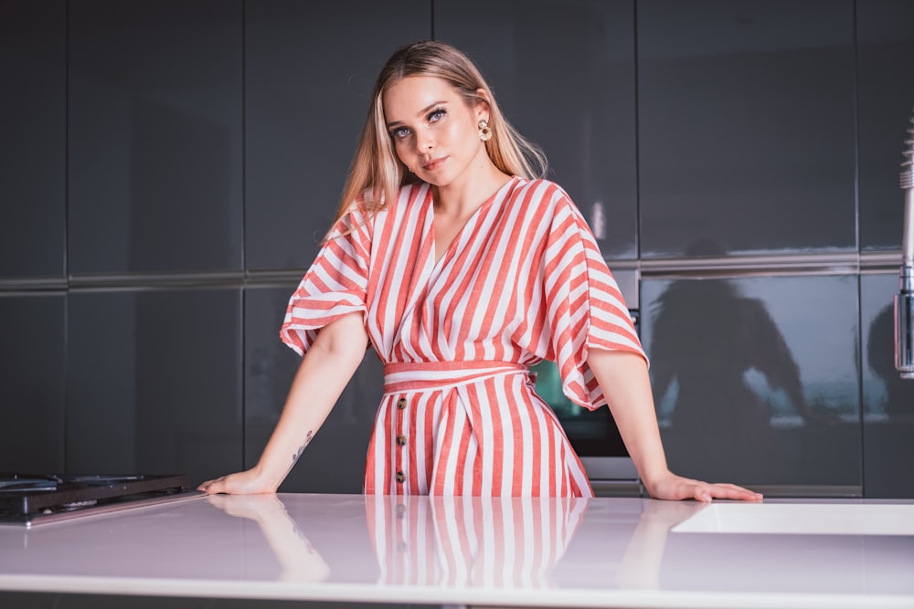 woman in red and white stripe dress