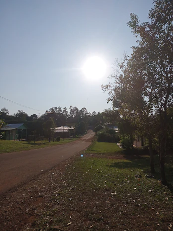 A transport vehicle driving through a quiet neighborhood on a clear day.
