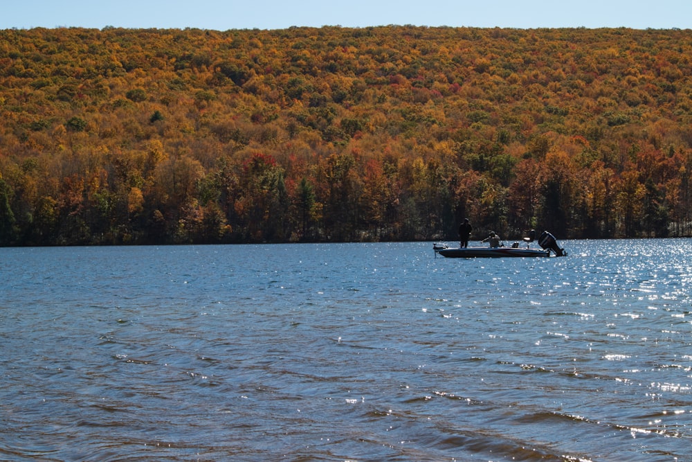 white boat on body of water during daytime