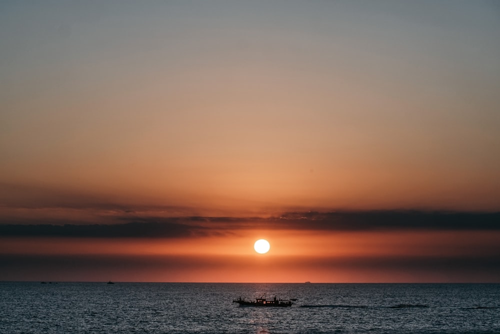 silhouette of people on sea during sunset