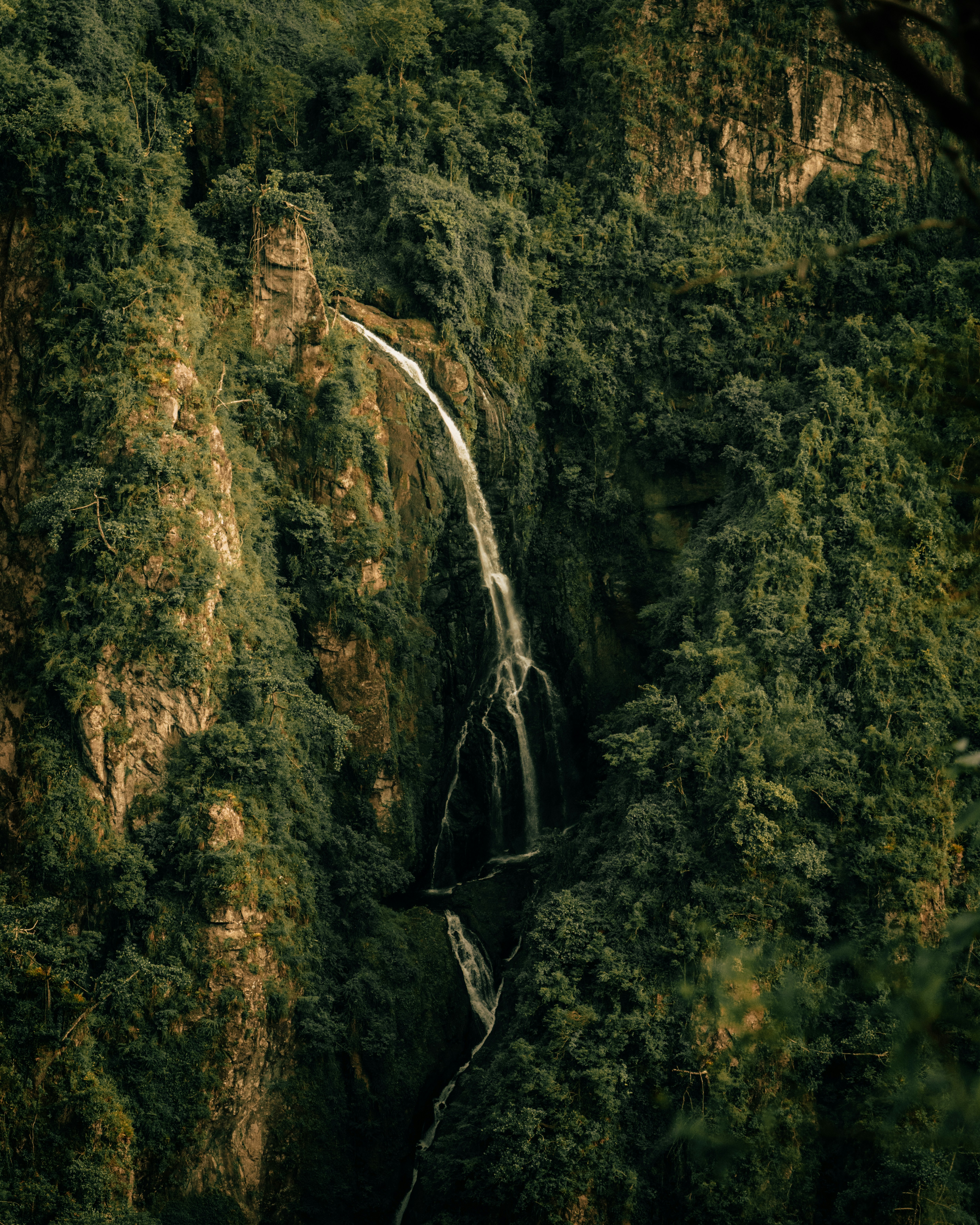 green and brown mountain with water falls