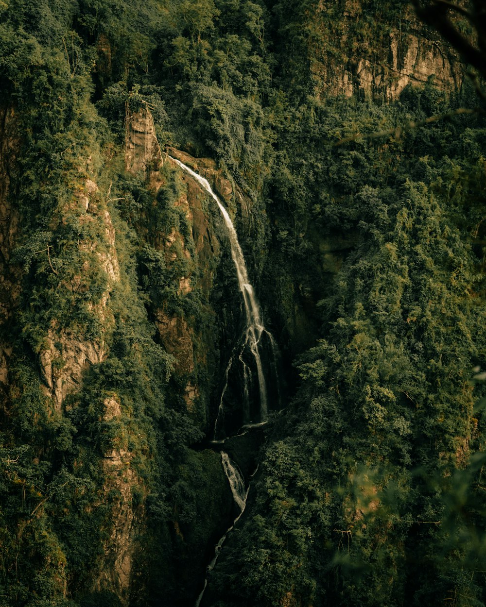 green and brown mountain with water falls