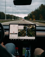 person holding white ipad inside car