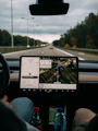 person holding white ipad inside car