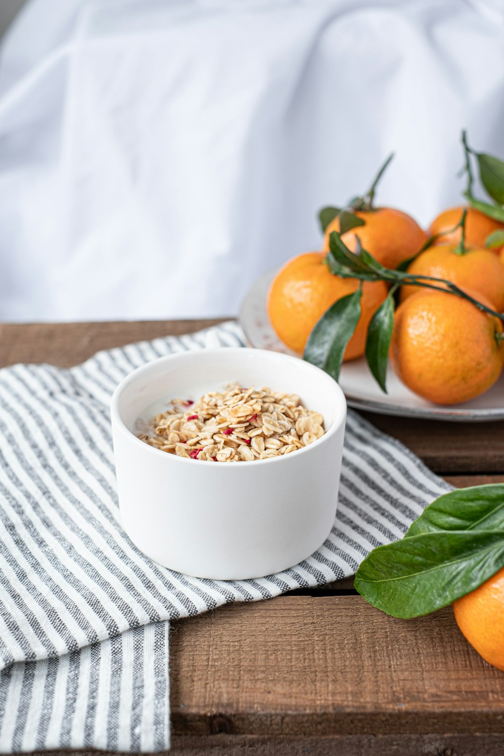 orange fruits on white ceramic bowl