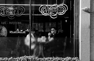 grayscale photo of man and woman sitting on chair