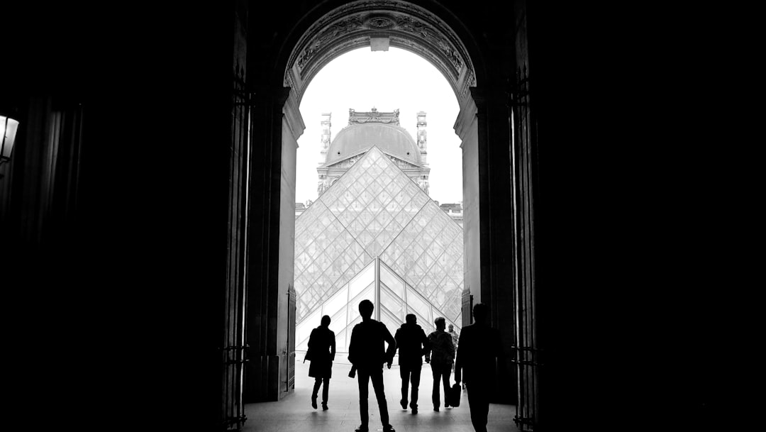 people walking on white concrete building