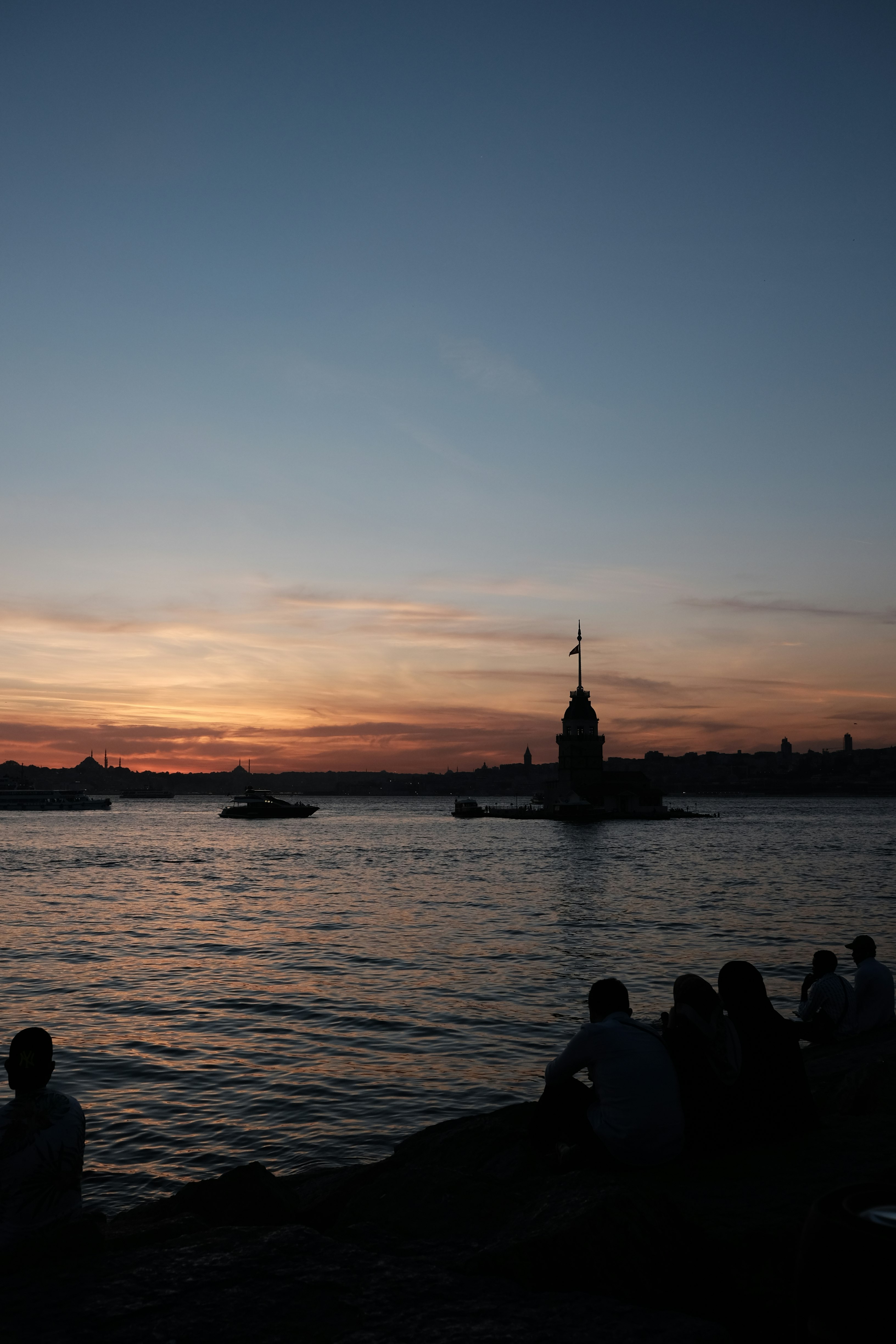 silhouette of people on beach during sunset