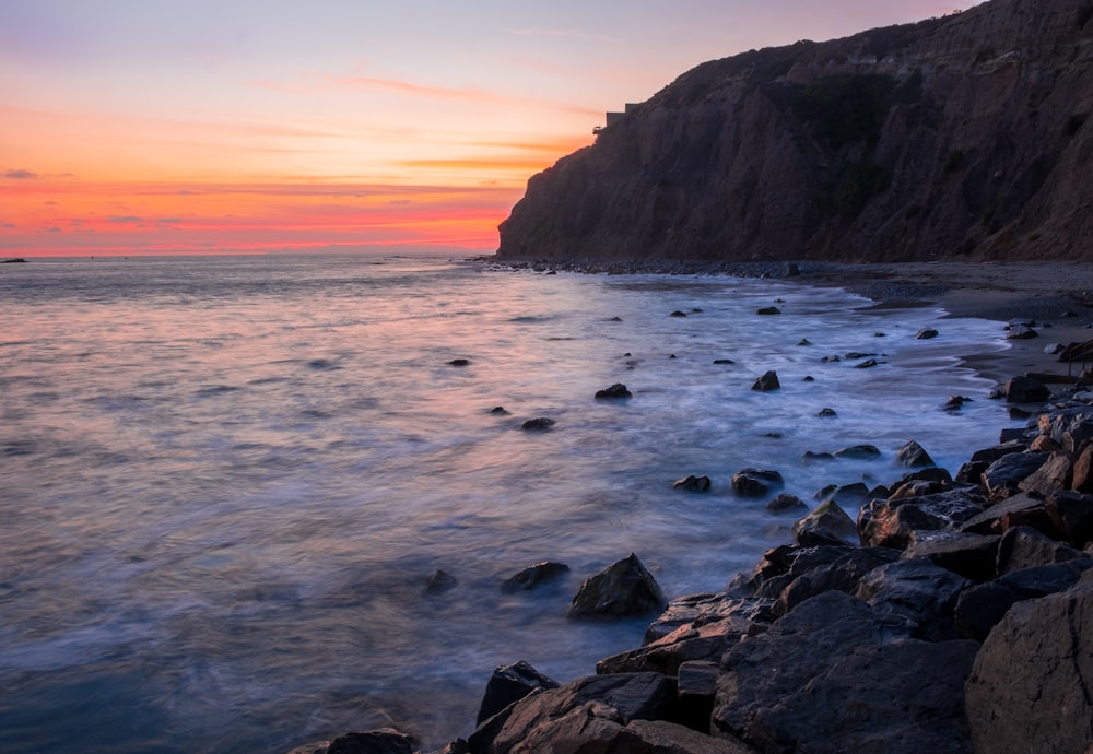 rocky shore with rocks during sunset