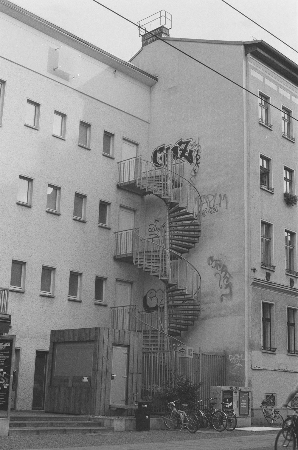 a black and white photo of a building with a spiral staircase