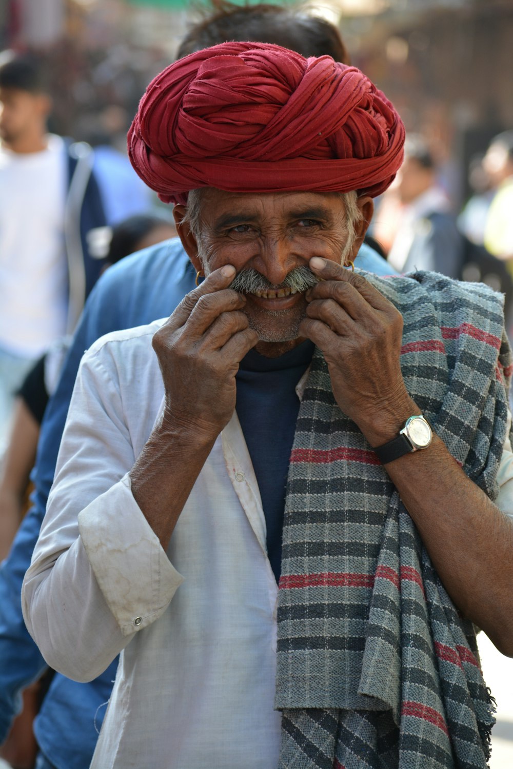 man in red and white plaid dress shirt wearing red hat