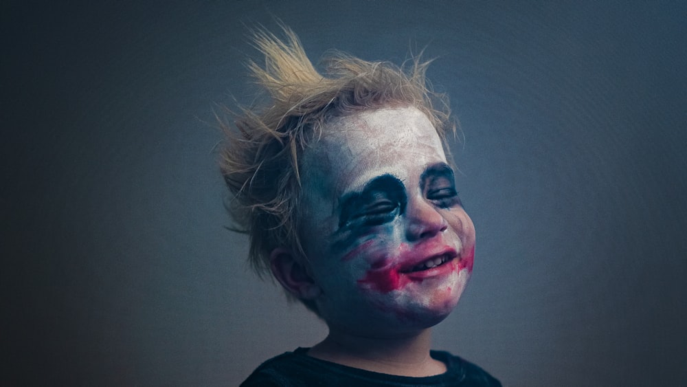 man in black crew neck shirt with face paint