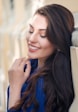 woman in blue long sleeve shirt smiling