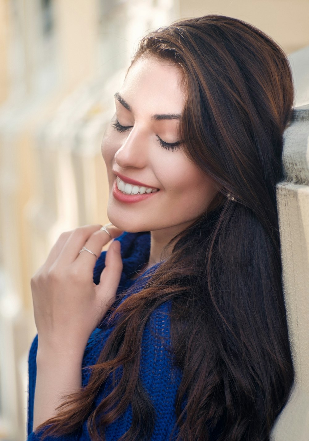 woman in blue long sleeve shirt smiling