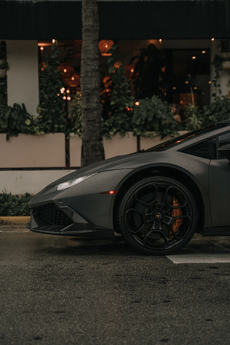 A matte black supercar parked at night