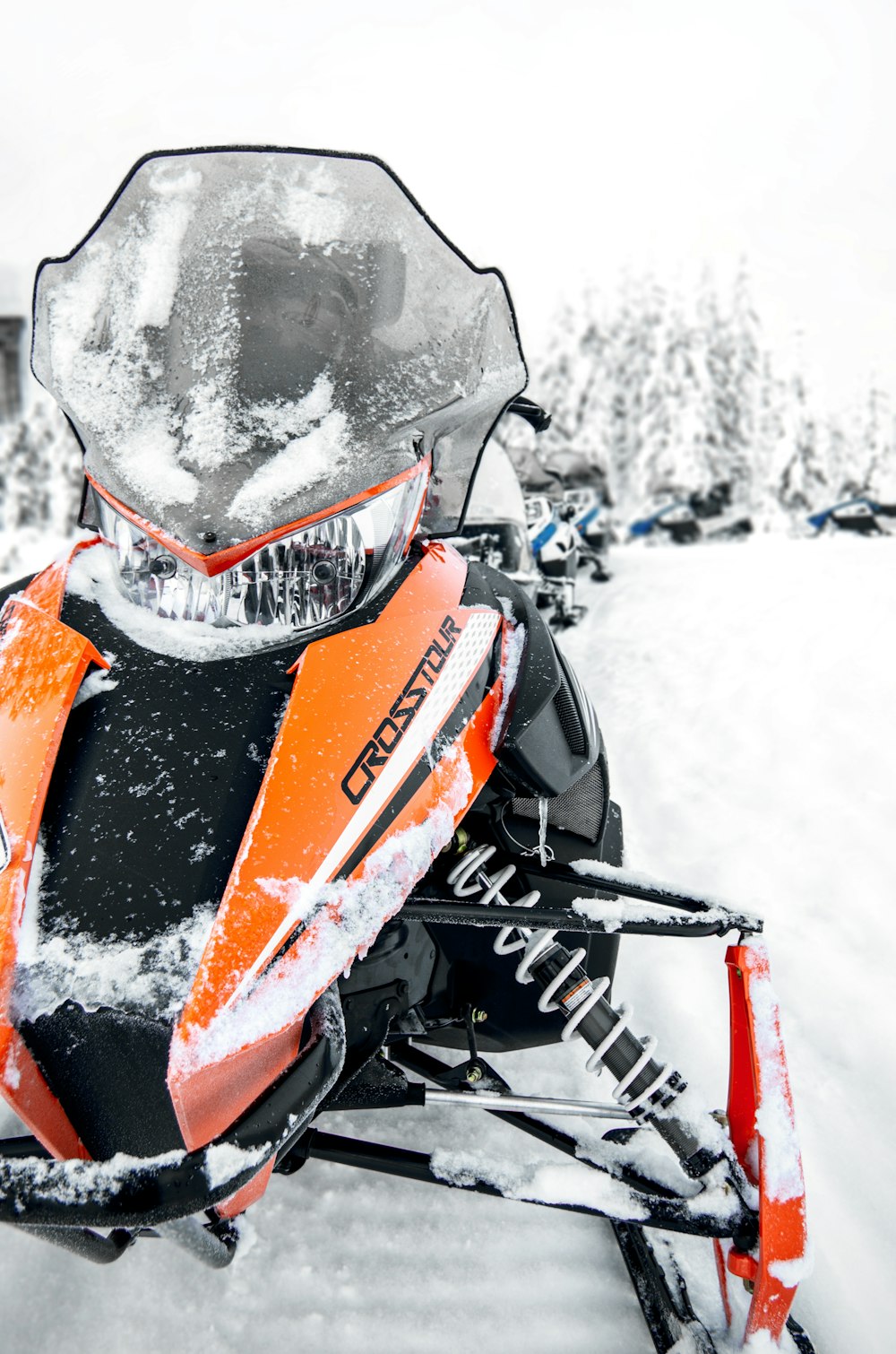 orange and black snow mobile