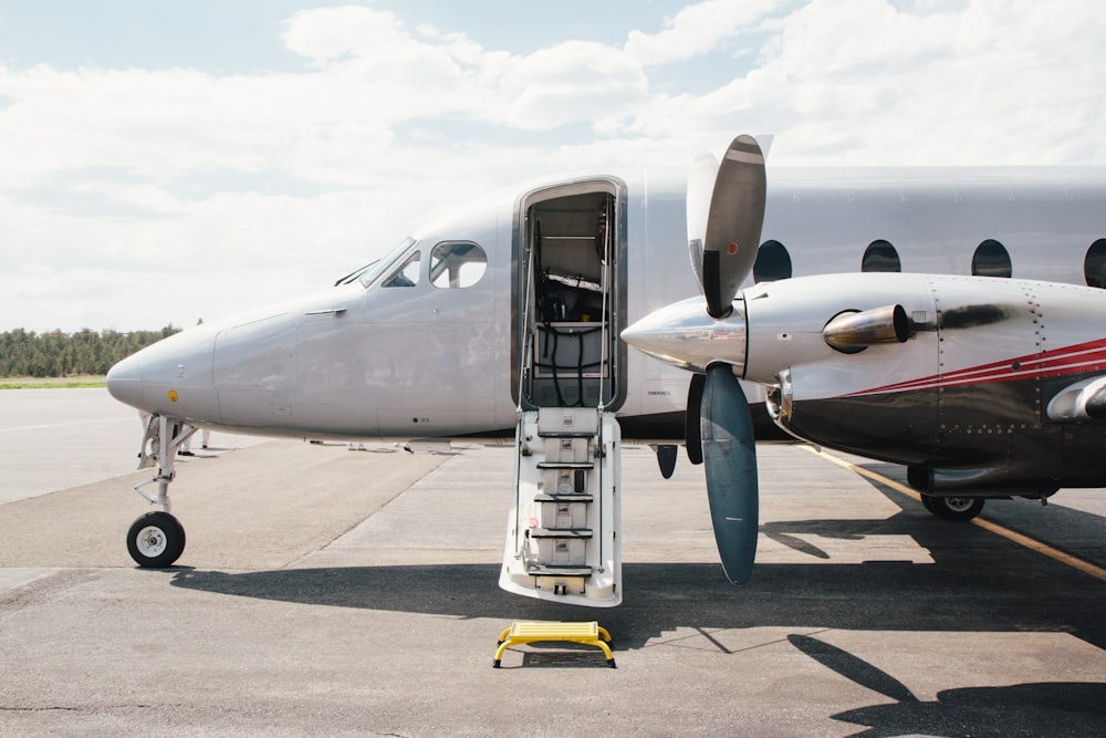 white and gray airplane on gray concrete ground during daytime