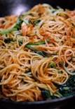 spaghetti with sauce on black plate