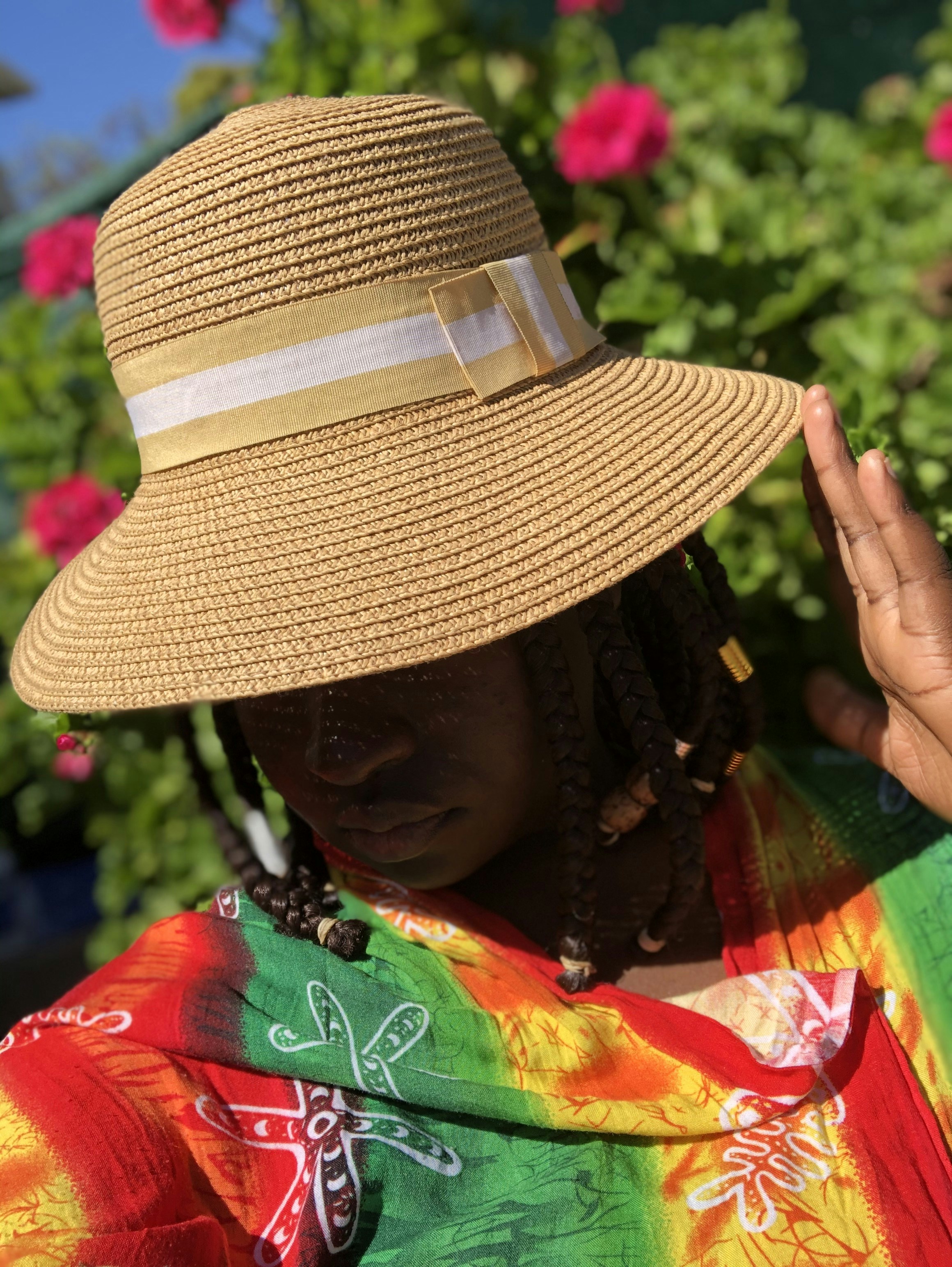 woman in brown and white sun hat