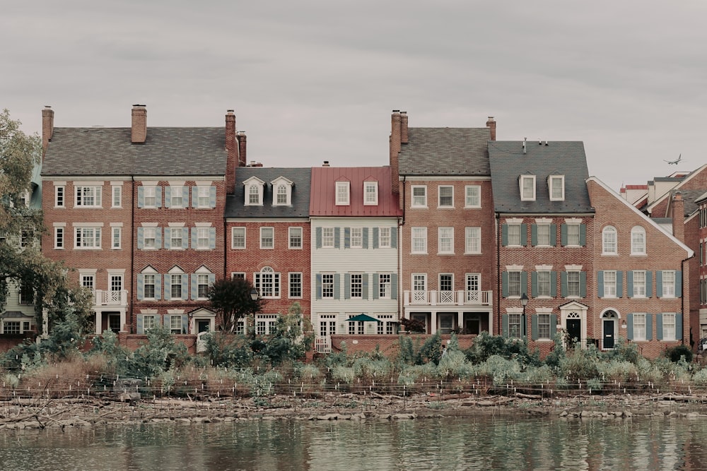 red and brown concrete building beside body of water during daytime