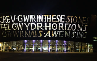 Illuminated channel letters glowing brightly on a business facade at dusk.