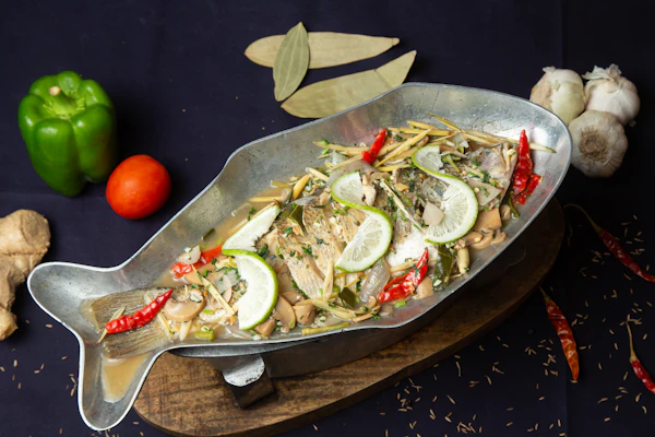 Kerala fish moilee — fish simmered in a pale golden coconut-milk curry with green chilli