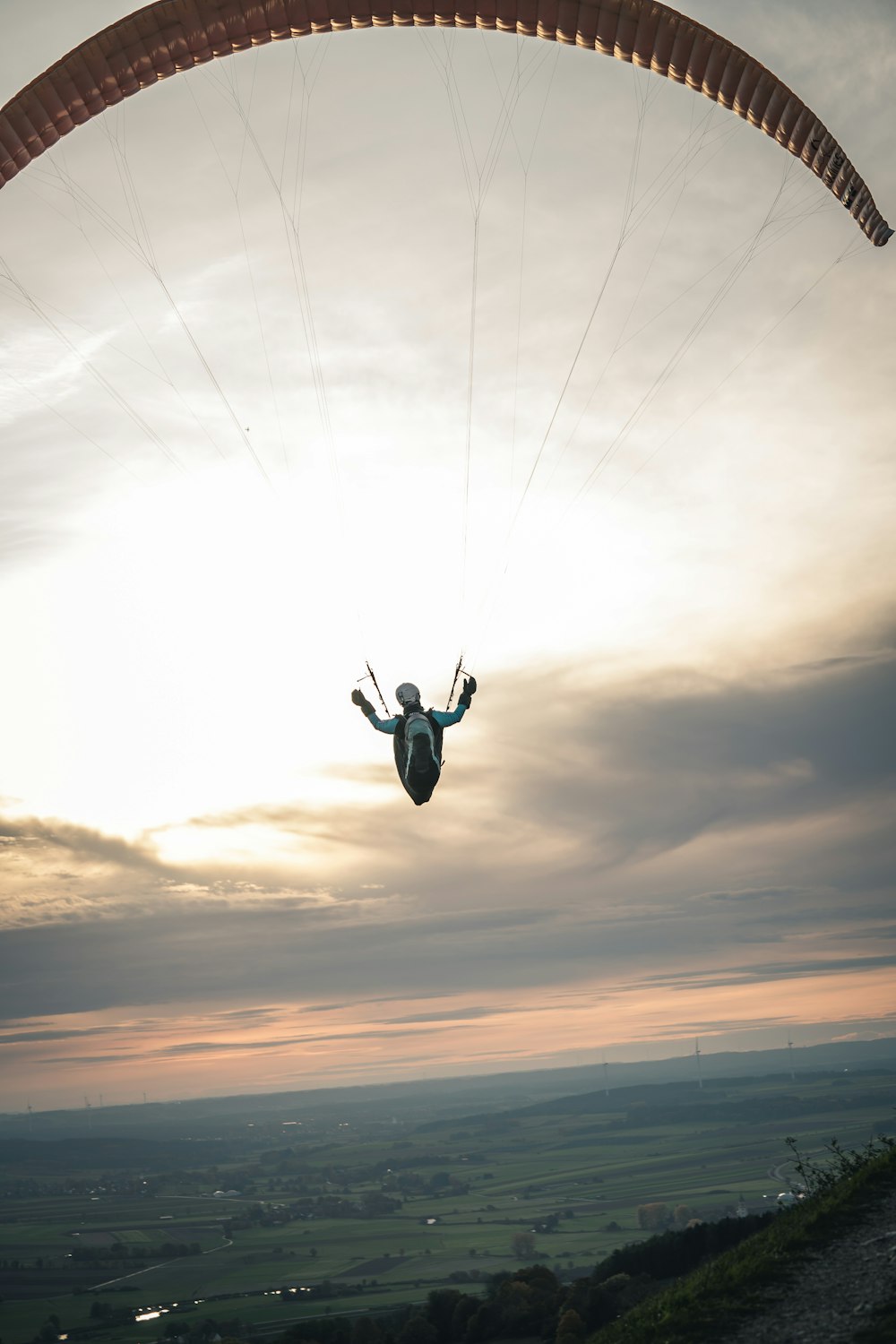 person in black and white parachute under white clouds during daytime