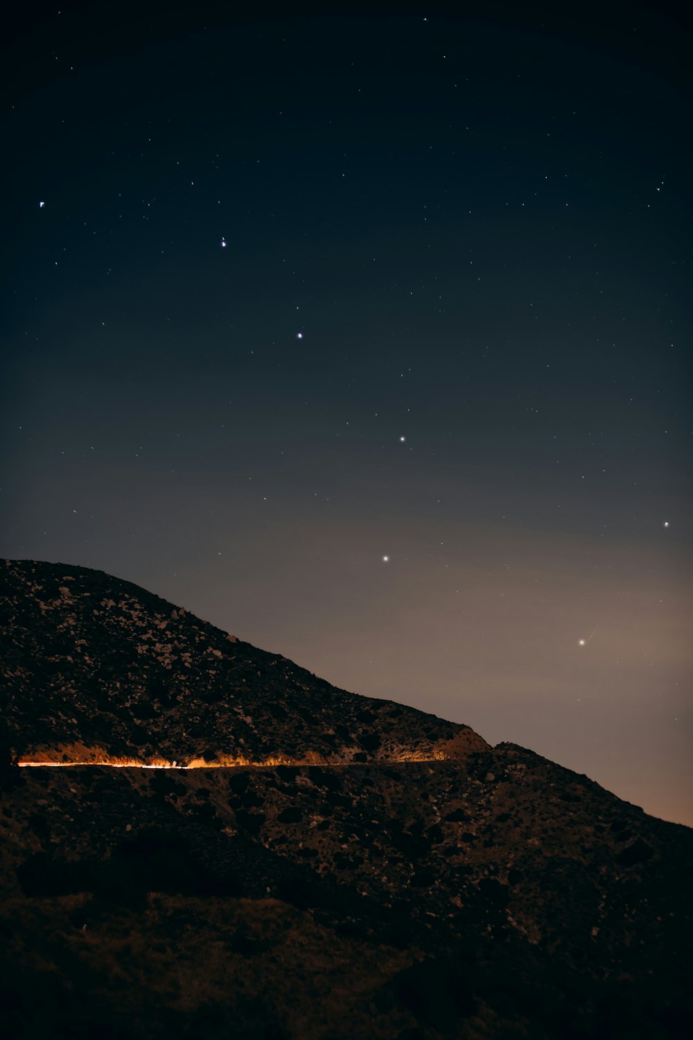 brown mountain under blue sky during night time