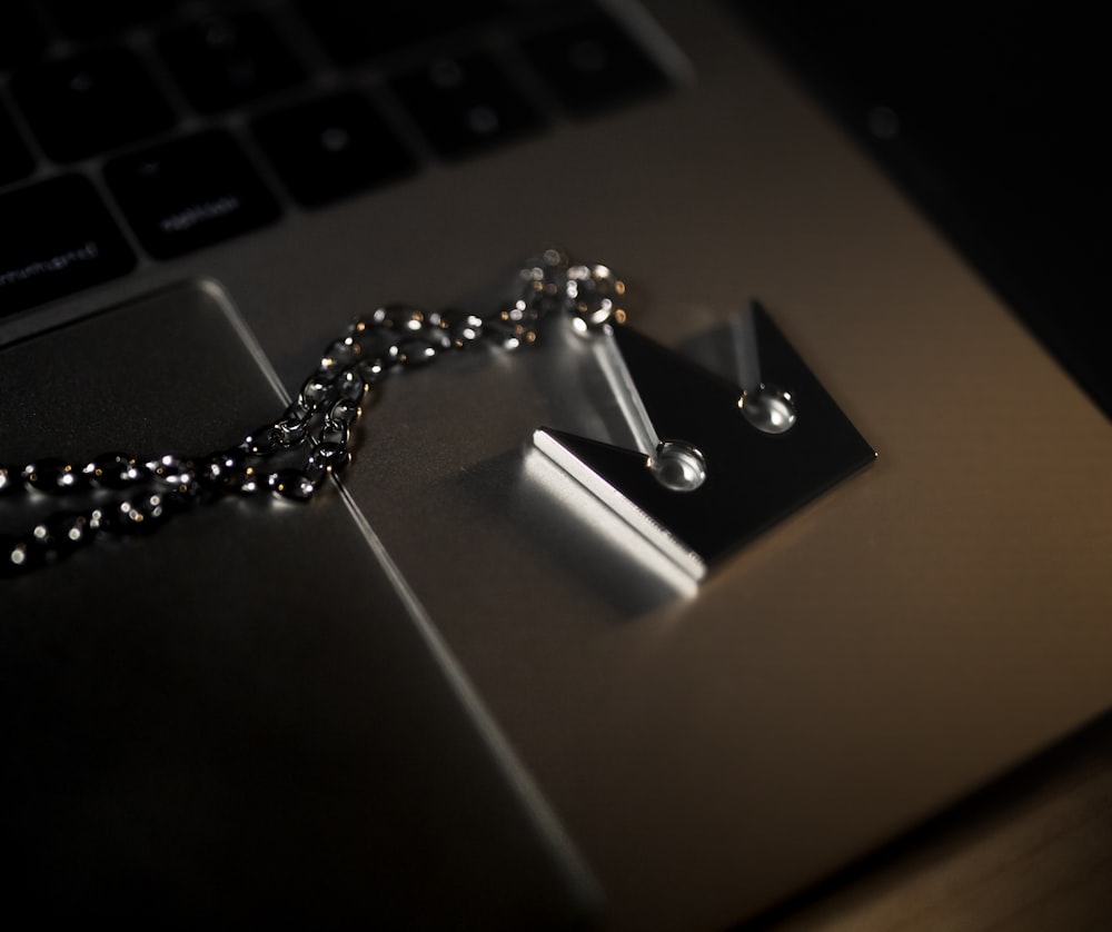 silver chain on silver laptop computer