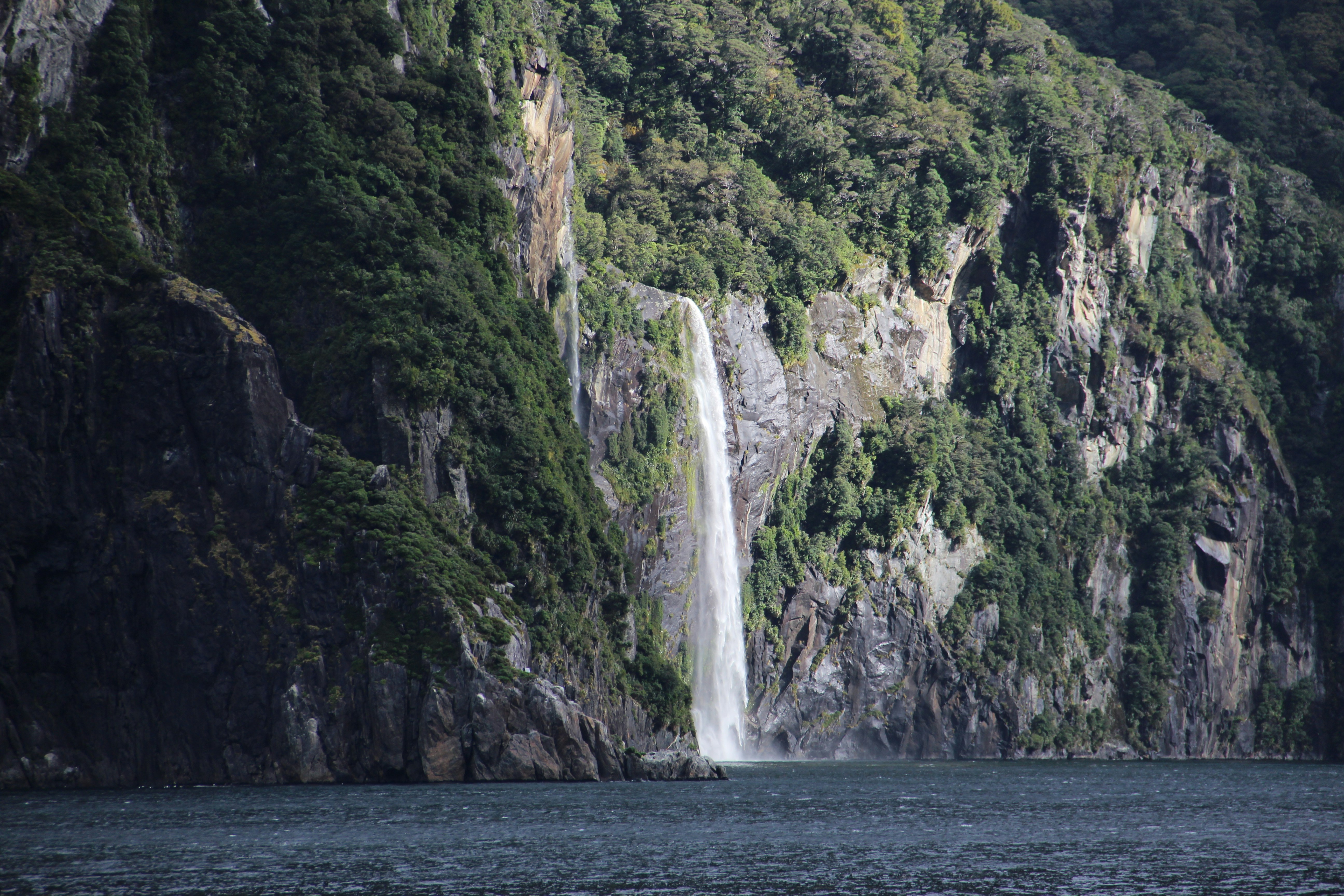 waterfalls on brown rocky mountain during daytime
