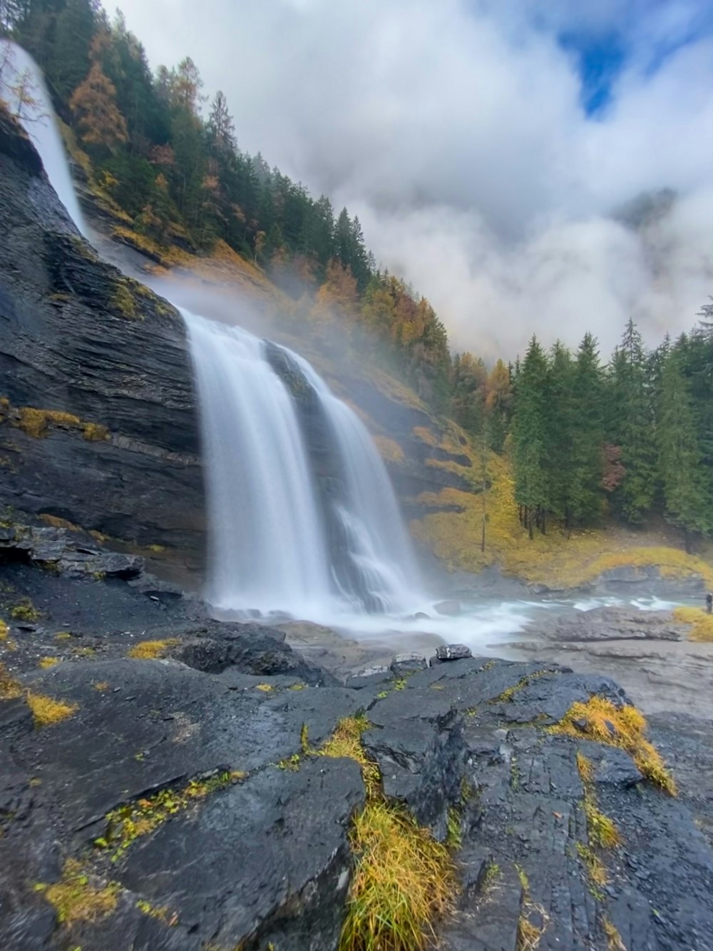 waterfalls on rocky mountain during daytime