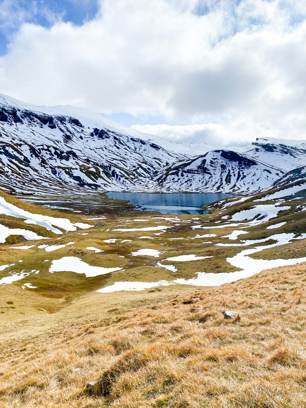 snow covered mountain near river during daytime