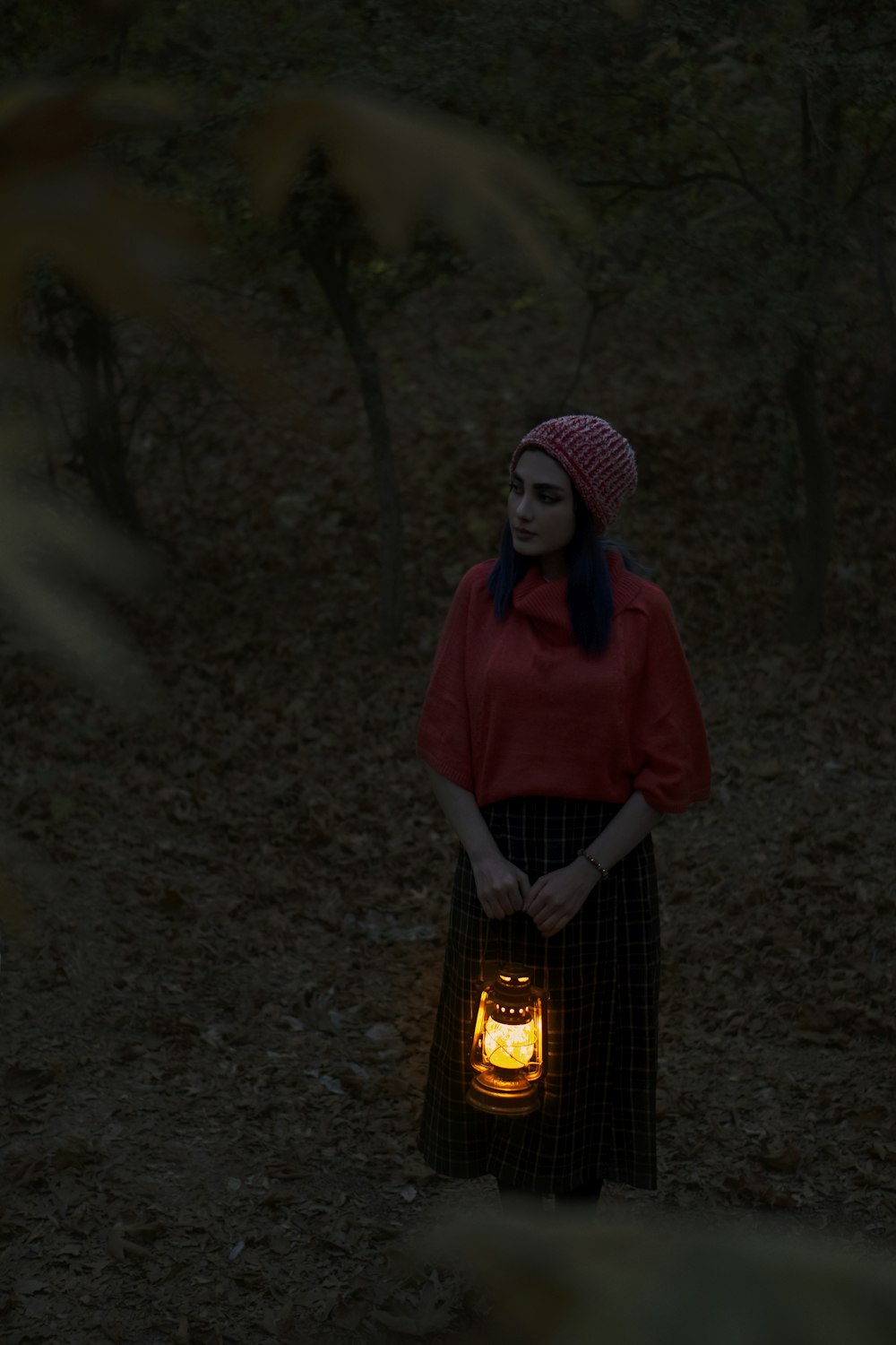 woman in red polo shirt standing in front of fire