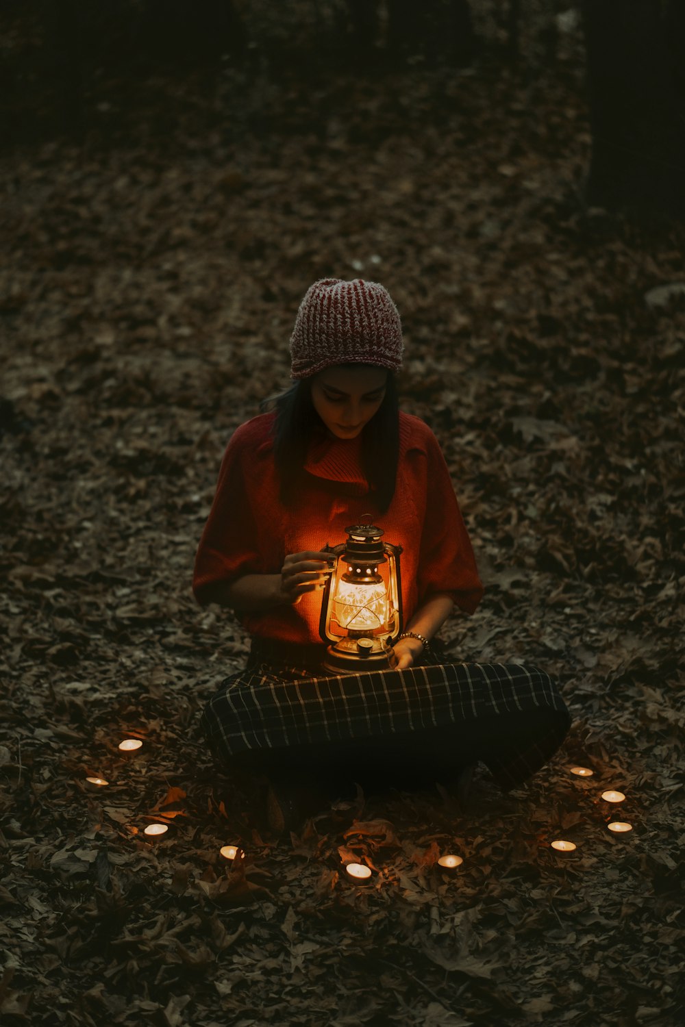 woman in red hoodie sitting on black metal bench