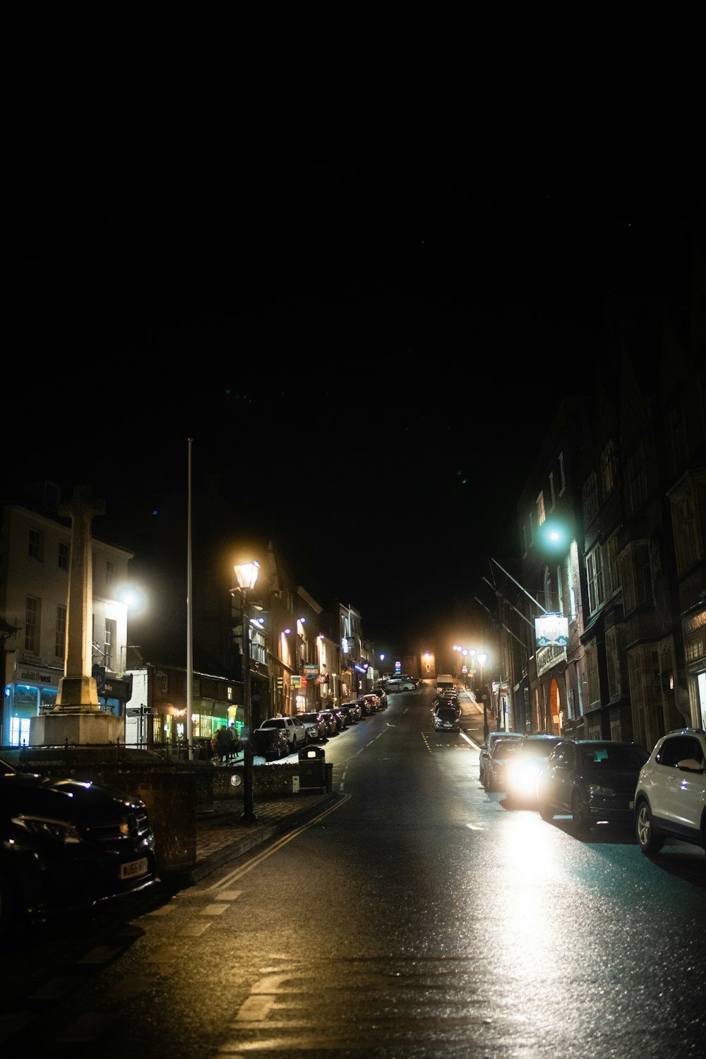 cars parked on side of the road during night time