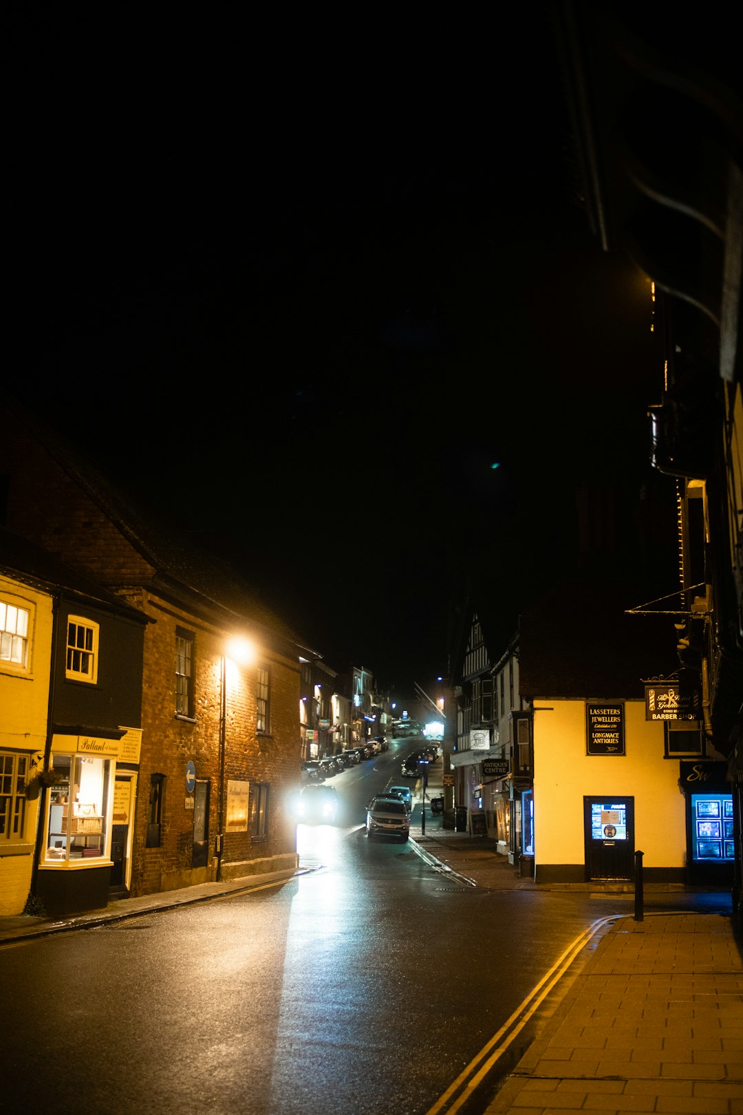 cars parked on side of the road during night time