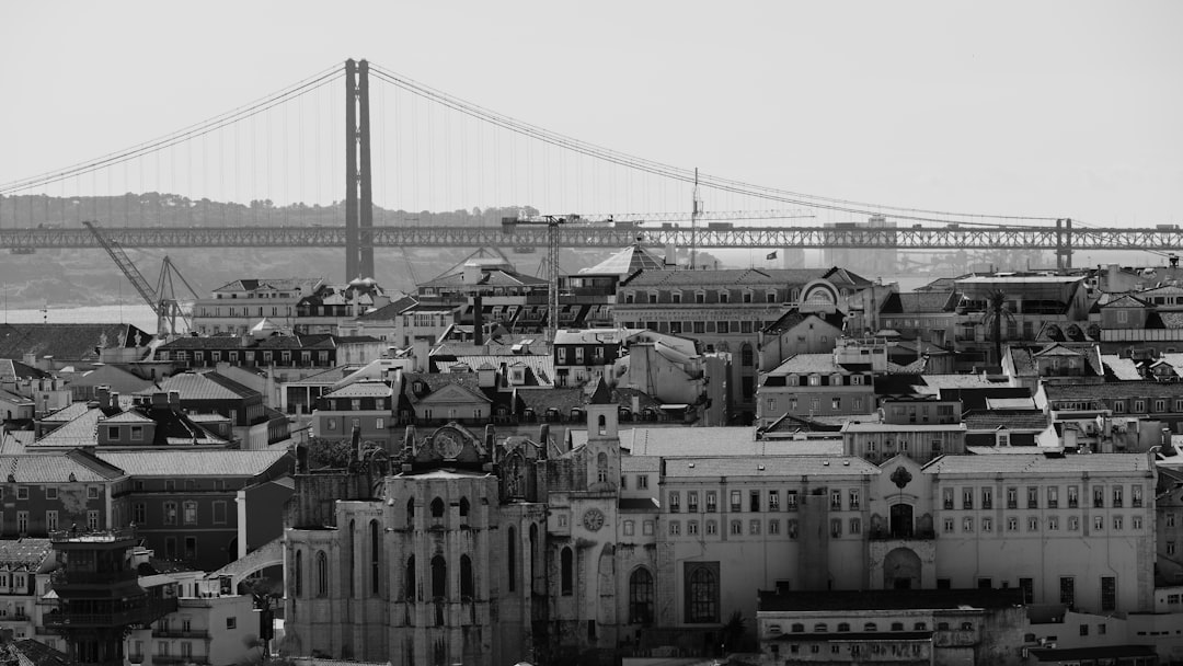 grayscale photo of bridge and buildings